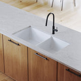 White kitchen sink with black faucet in a modern kitchen setting