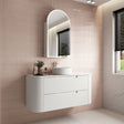 Bathroom vanity with sink and mirror against a tiled wall.