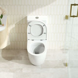 White toilet in a bathroom with tiled walls and floor