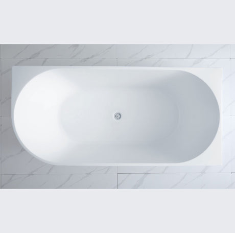 White oval bathtub in a bathroom with marble tiles