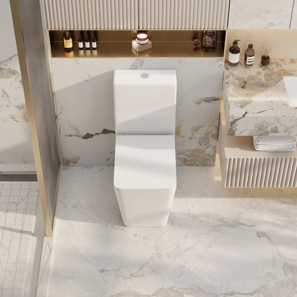 Modern bathroom with a freestanding white bathtub against a marble wall.