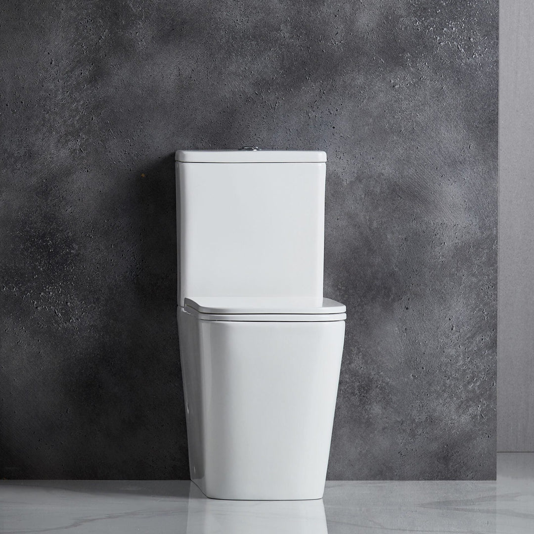 White toilet against a gray concrete wall