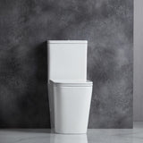 White toilet against a gray concrete wall