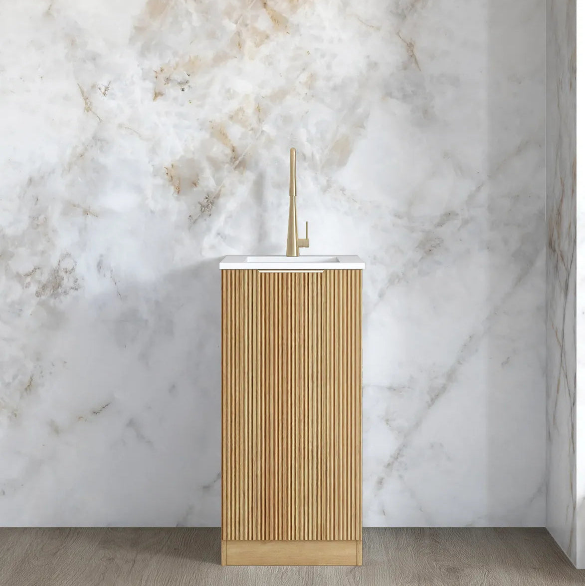 Modern bathroom sink with gold finish against a marble wall
