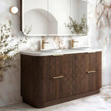 A modern double-sink bathroom vanity with a dark brown ribbed wood cabinet, white countertop, and a large three-panel mirror mounted on a marble-patterned wall.