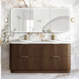A modern double-sink bathroom vanity with a ribbed brown wood cabinet, white countertop, and a large triptych mirror mounted on a white marble wall.