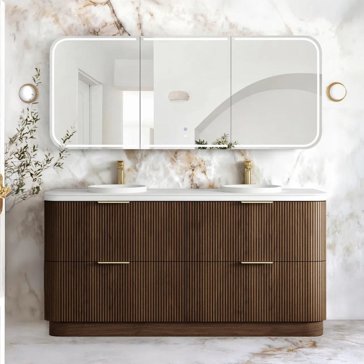 A modern double-sink bathroom vanity with a ribbed brown wood cabinet, white countertop, and a large triptych mirror mounted on a white marble wall.