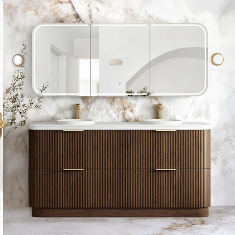 A modern double-sink bathroom vanity with a ribbed brown wood cabinet, white countertop, and a large triptych mirror mounted on a white marble wall.