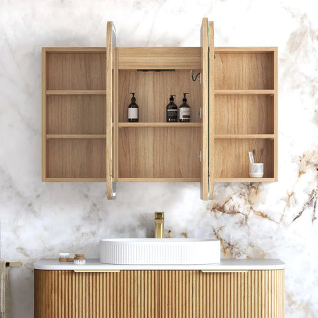 Bathroom vanity with wooden cabinets and marble wall