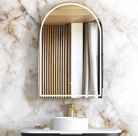 Bathroom vanity with a decorative mirror on a marble wall