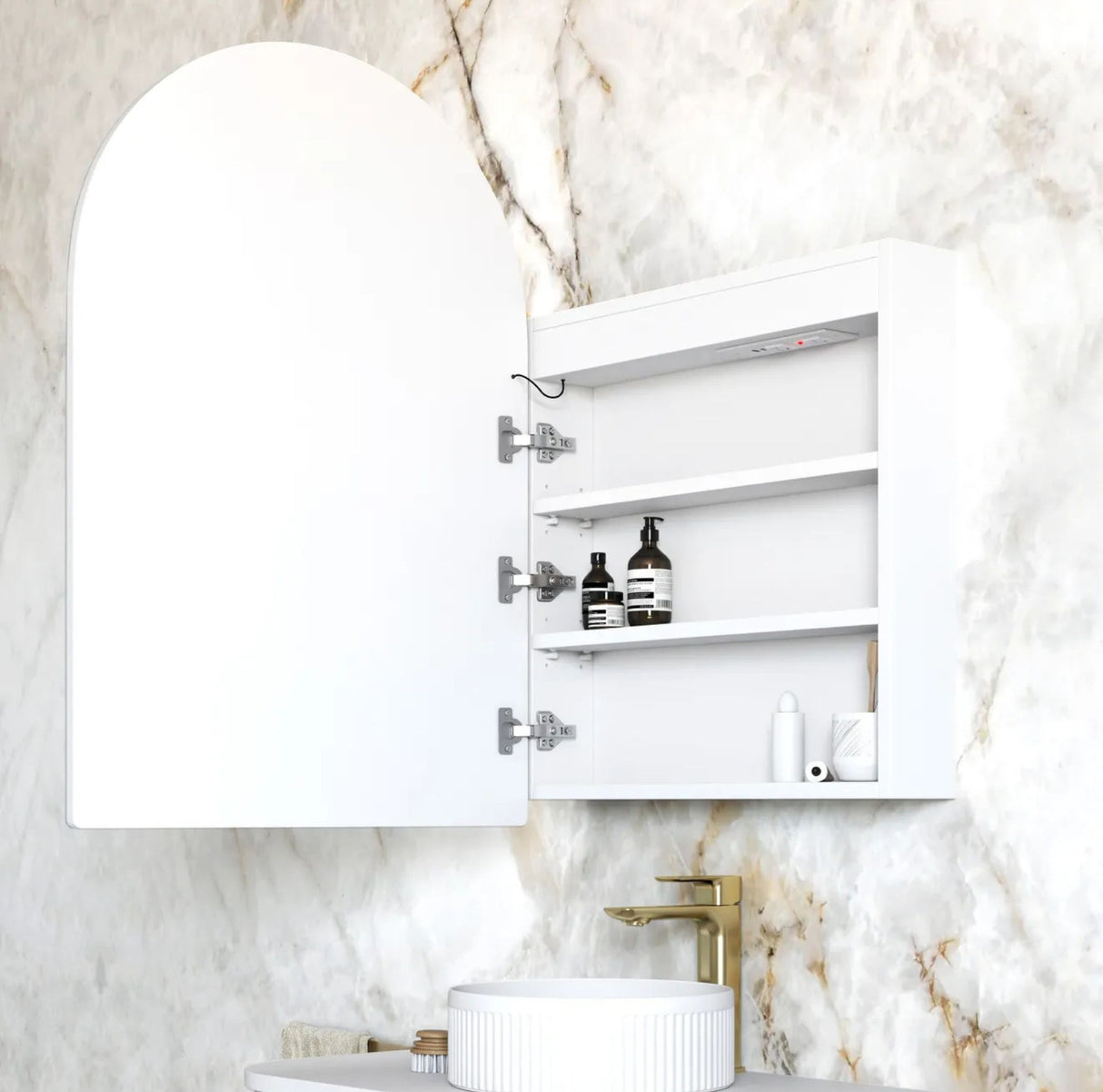 White bathroom cabinet with open door on a marble wall background