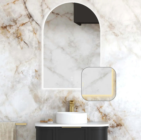 Bathroom interior with a marble wall, sink, and mirror.
