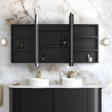 Bathroom setup with black cabinets, white marble wall, and gold accents.