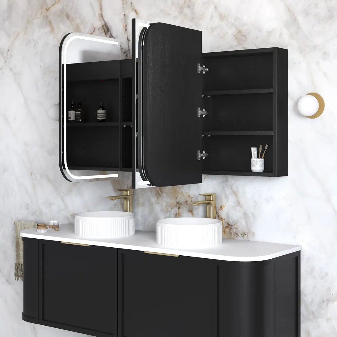 Bathroom vanity with black cabinets, white countertop, and mirror on marble wall.