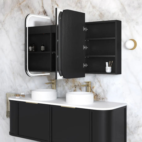 Bathroom vanity with black cabinets, white countertop, and mirror on marble wall.