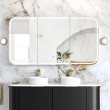 Bathroom vanity with black cabinets, white marble countertop, and large mirror with light fixture.