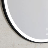 Round mirror with a black frame on a light gray wall