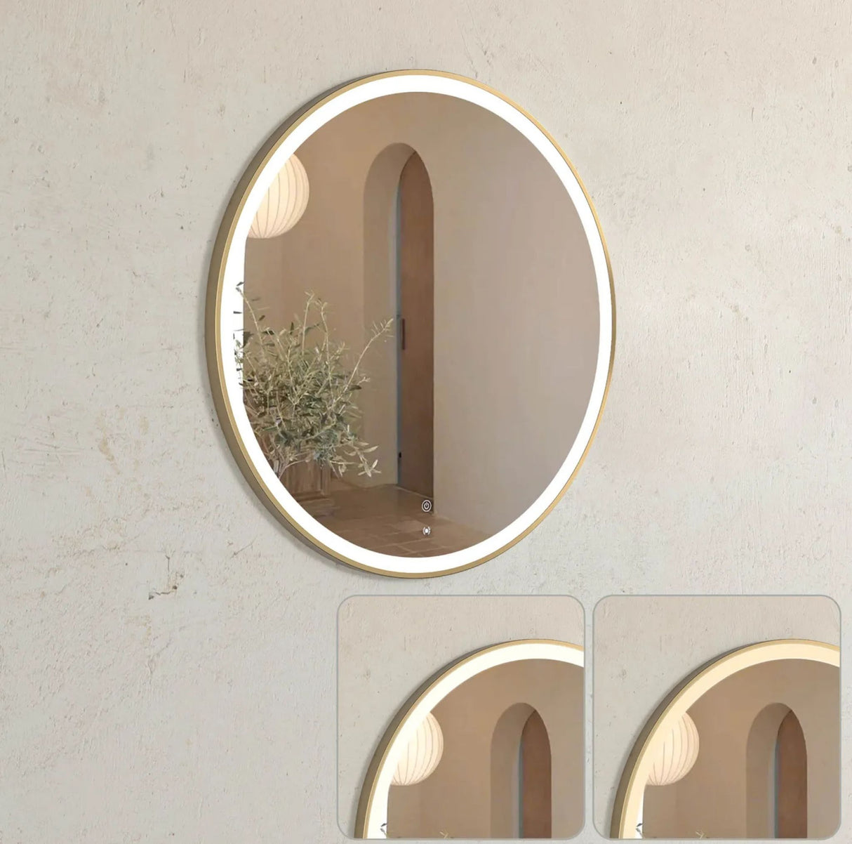 Round wall mirror with gold frame on a light beige wall.