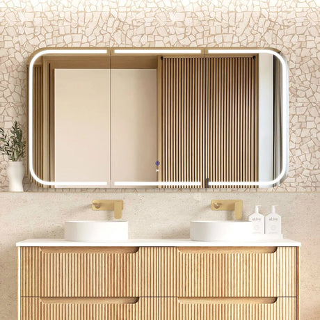 Bathroom vanity with a large mirror, light fixture, and decorative elements.