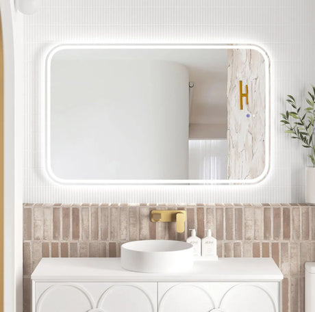 Bathroom vanity with a large mirror and decorative elements.