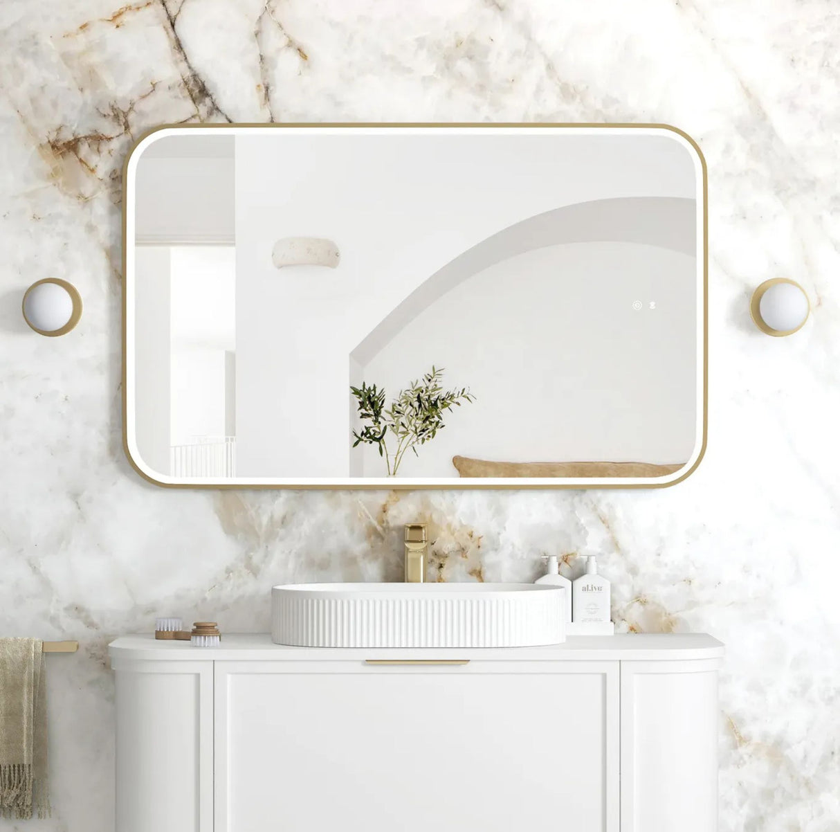 Bathroom vanity with a rectangular mirror on a marble wall