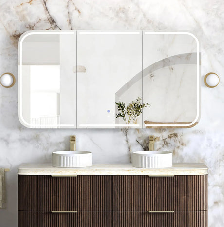 Bathroom vanity with double sink, mirror, and marble wall.