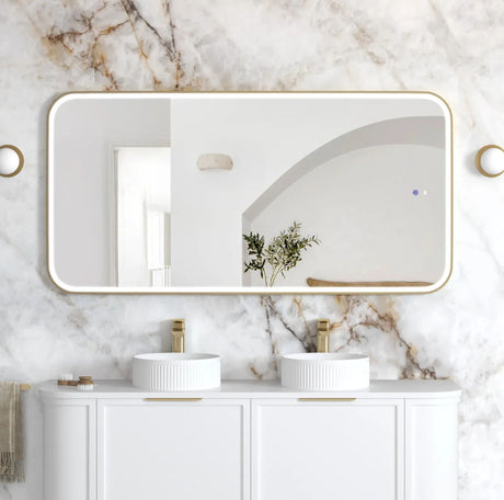Bathroom with marble walls, white vanity, and gold fixtures