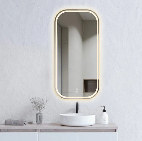 Bathroom vanity with a rectangular mirror with LED lighting, sink, and toiletries.