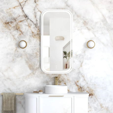 Bathroom vanity with mirror and sink against a marble wall