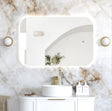 Bathroom with marble walls, a sink, and decorative elements.