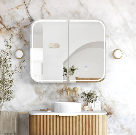 Bathroom vanity with a mirror on a marble wall