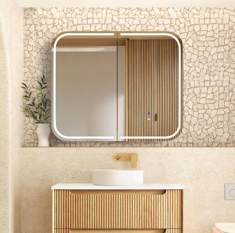 Bathroom vanity with a mirror and sink against a mosaic-tiled wall.