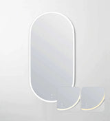 LED oval mirror with a white metal frame, featuring soft ambient backlighting in adjustable tones. The mirror includes touch controls for brightness and lighting color, showcased in the two inset images for warm and cool light variations. Ideal for modern, minimalist interiors.