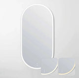 Modern wall mirror with two decorative plates on a light gray background