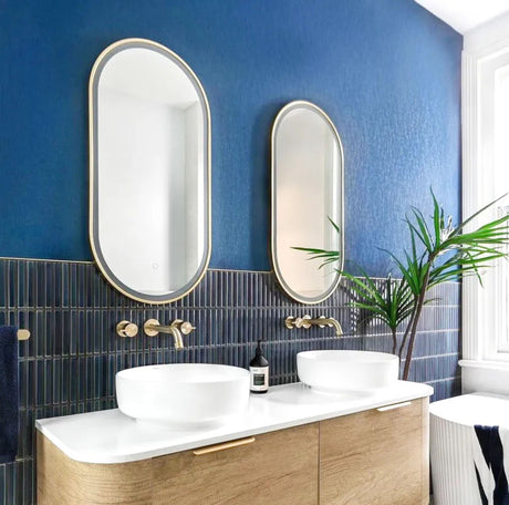 Bathroom with blue walls, white sink, and gold fixtures