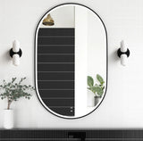 Oval vertical mirror on a wall with decorative elements