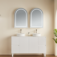 Bathroom vanity with two sinks and mirrors on a beige wall.