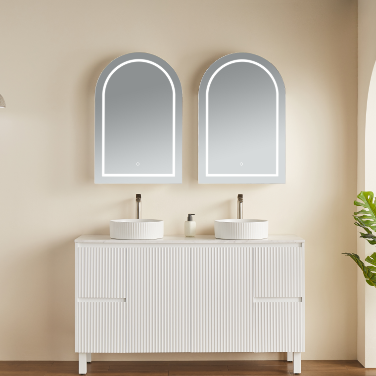 Bathroom vanity with two sinks and mirrors on a beige wall.