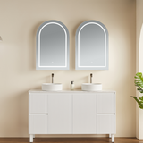 Bathroom vanity with two sinks and mirrors on a beige wall.