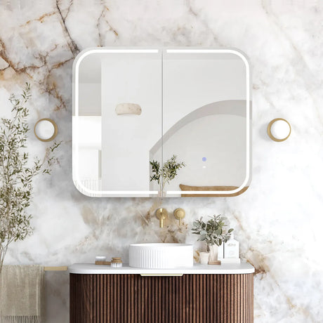 Bathroom interior with a vanity, mirror, and decorative elements on a marble wall.