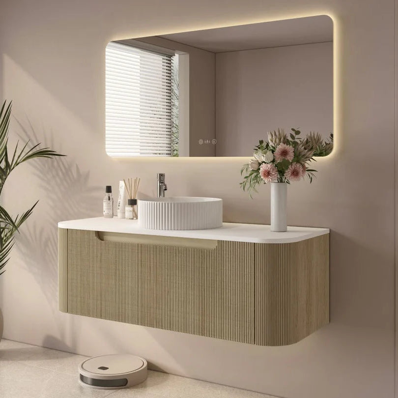 Modern bathroom with a vanity, mirror, and decorative elements.