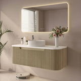 Modern bathroom with a vanity, mirror, and decorative elements.