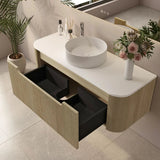 Bathroom vanity with a sink, flowers, and toiletries on a light-colored floor.