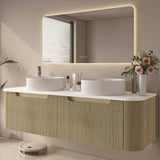 Modern bathroom with a double sink vanity, mirror, and decorative elements.