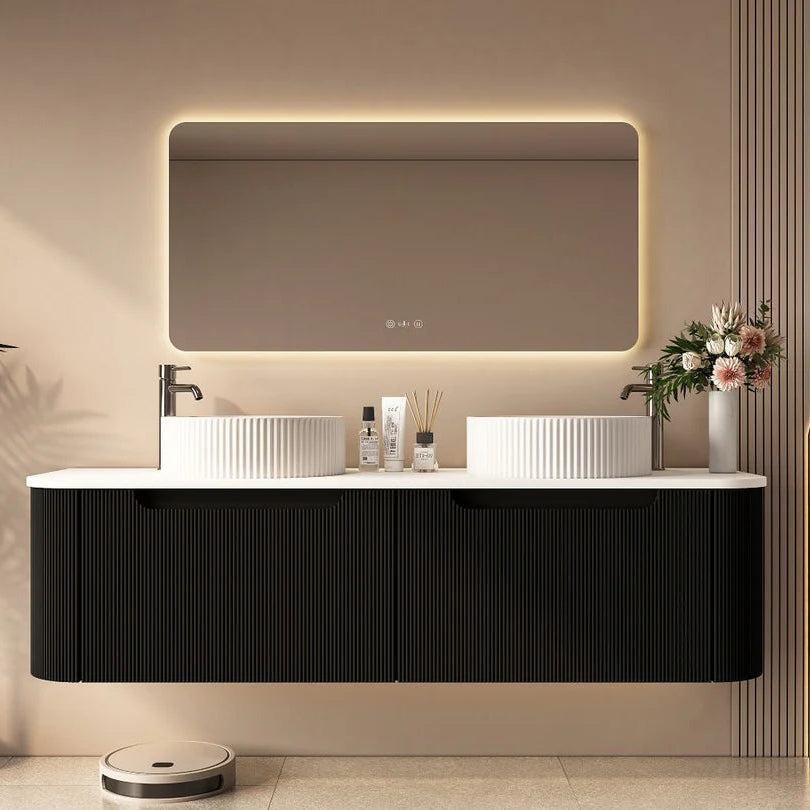 Modern bathroom vanity with illuminated mirror and decorative elements.