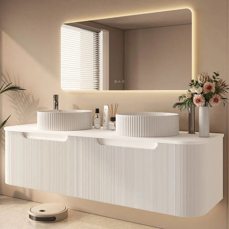 Modern bathroom with a double sink vanity, mirror, and decorative elements.
