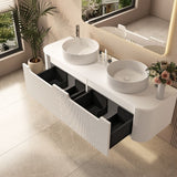 Bathroom vanity with two round sinks, black drawers, and a vase of flowers.