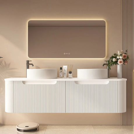 Modern bathroom with a white vanity, illuminated mirror, and decorative elements.
