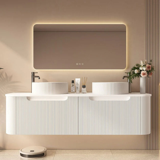 Modern bathroom with a white vanity, illuminated mirror, and decorative elements.
