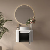 Bathroom setup with a round mirror, sink, and decorative elements on a beige wall.